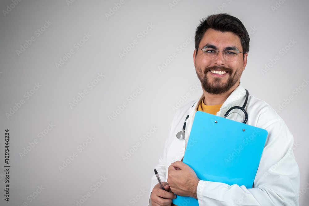 Portrait of confident young doctor on white background. Male doctor standing with pen and medical records in hand on white background. Portrait of confident young doctor on white background. Male doctor standing with pen and medical records in hand on white background.