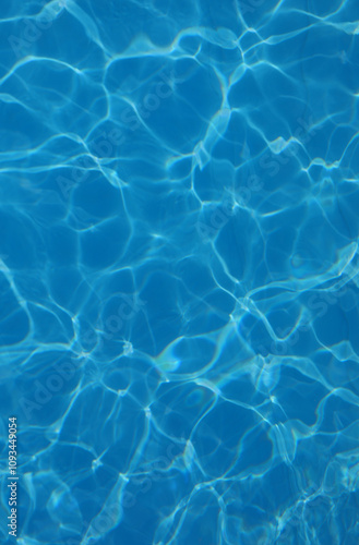 background of azure pool water with light reflections without other people or objects