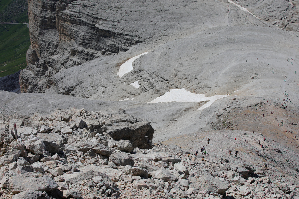 tiny ant-like people climbing the stony path in the European Alps on the Dolomites mountain range in Italy tiny ant-like people climbing the stony path in the European Alps on the Dolomites mountain range in Italy