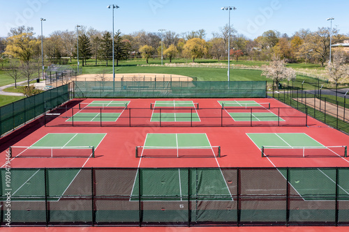 Aerial view of pickleball facility with red and green courts