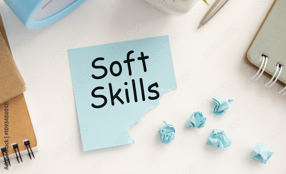 On a white background lies a notebook, a pen, clothespins and cardboard with the inscription - Soft Skills On a white background lies a notebook, a pen, clothespins and cardboard with the inscription - Soft Skills