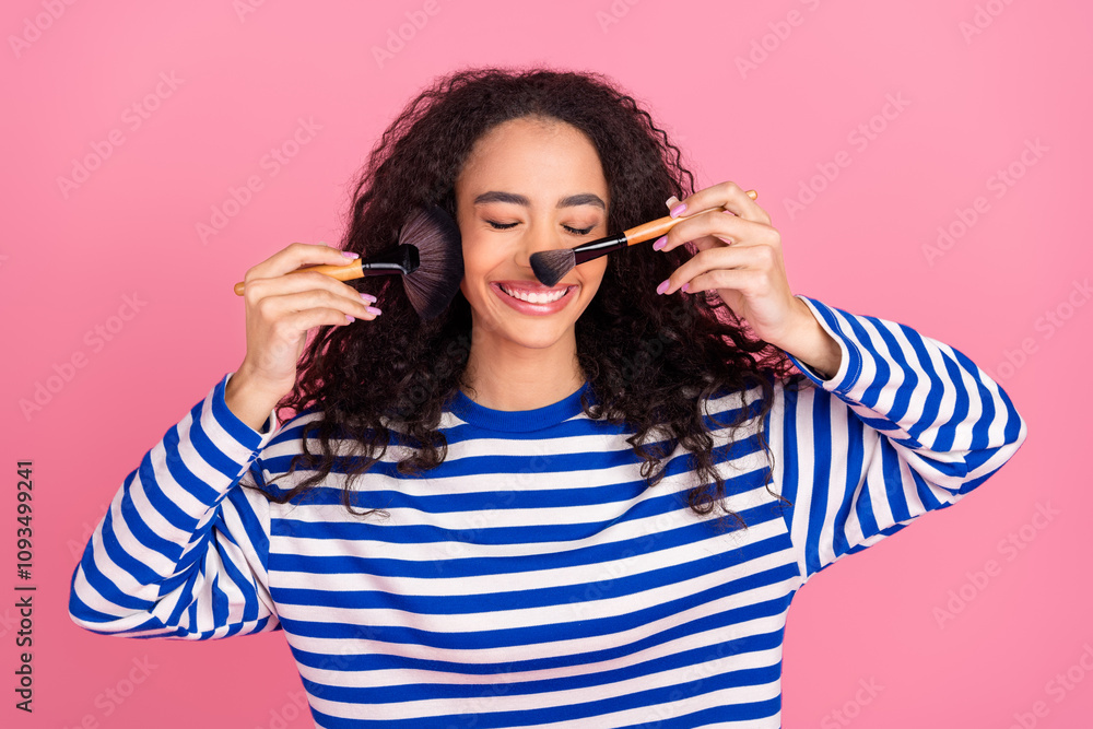 Fototapeta premium Portrait of nice young girl apply blush tone wear striped pullover isolated on pink color background