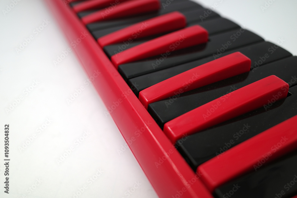 The keys of a black and red melodica. A melodica is a musical instrument similar to a pump organ or harmonica. The keys of a black and red melodica. A melodica is a musical instrument similar to a pump organ or harmonica.