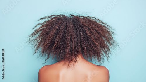 Young adult with coarse unruly natural hair that looks dry tangled and challenging to maintain photo