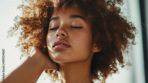 Young adult with coarse unruly natural hair that looks dry tangled and challenging to maintain photo