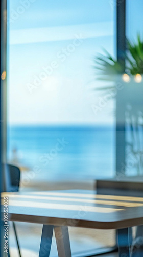 Vertical photo of s blurred co-working space with a large window and a blue ocean view photo