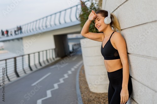 A young woman enjoys music ...