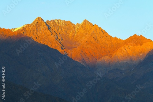 Last sun's rays touching the mountain range that borders high-altitude Sarfaranga Cold Desert located near the village of Shigar (Gilgit-Baltistan, Pakistan) photo