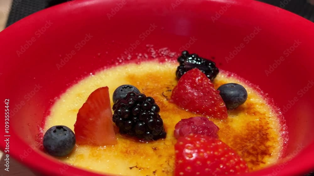fruit creme brulee Panning shot of creme brulee with strawberry and mint leaf on top raspberry blueberry blackberry strawberry fruit creme brulee Panning shot of creme brulee with strawberry and mint leaf on top raspberry blueberry blackberry strawberry