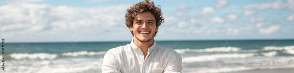 A smiling young man stands on a beach, enjoying a sunny day by the ocean. A smiling young man stands on a beach, enjoying a sunny day by the ocean.