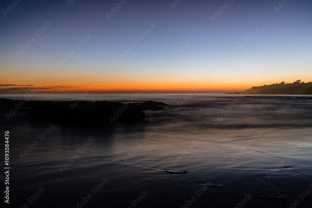 sunset over ocean with mountains sunset over ocean with mountains
