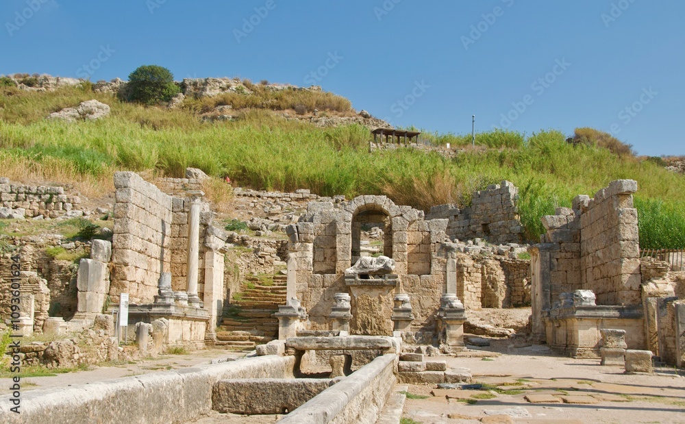 The main street with fountain in the ancient city of Perge Ruins in Turkey