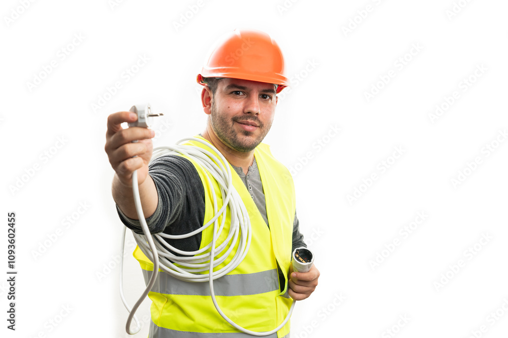 Builder man with friendly expression showing white plug Builder man with friendly expression showing white plug