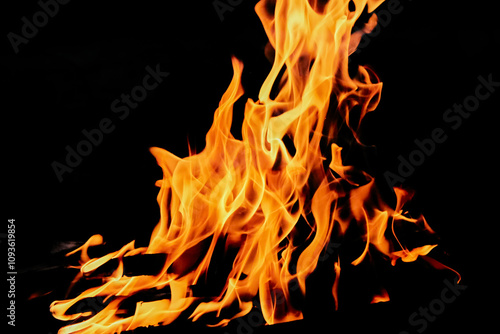 bright fiery dancing flame on black background