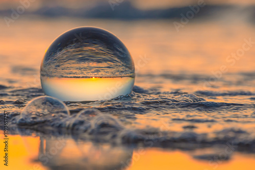 Glass ball on the beach photo