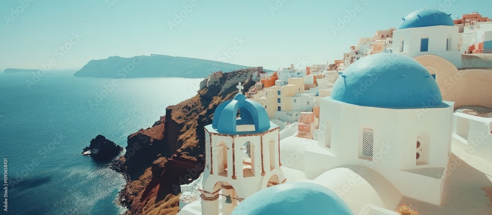 Naklejka premium Blue-Domed Church on a Cliffside in Santorini, Greece