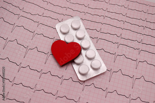 Photos Red heart and pills on ecg