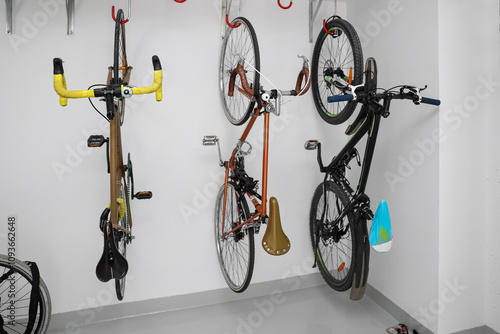Fotografie Modern bicycles hanging on light wall