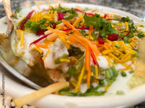 Indian Chaat with Curd, Sweet Sauce and many other ingredients served in a plate photo