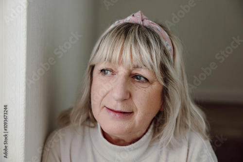 Tablou pe pânză senior woman anxiously looking out waiting, caucasian white