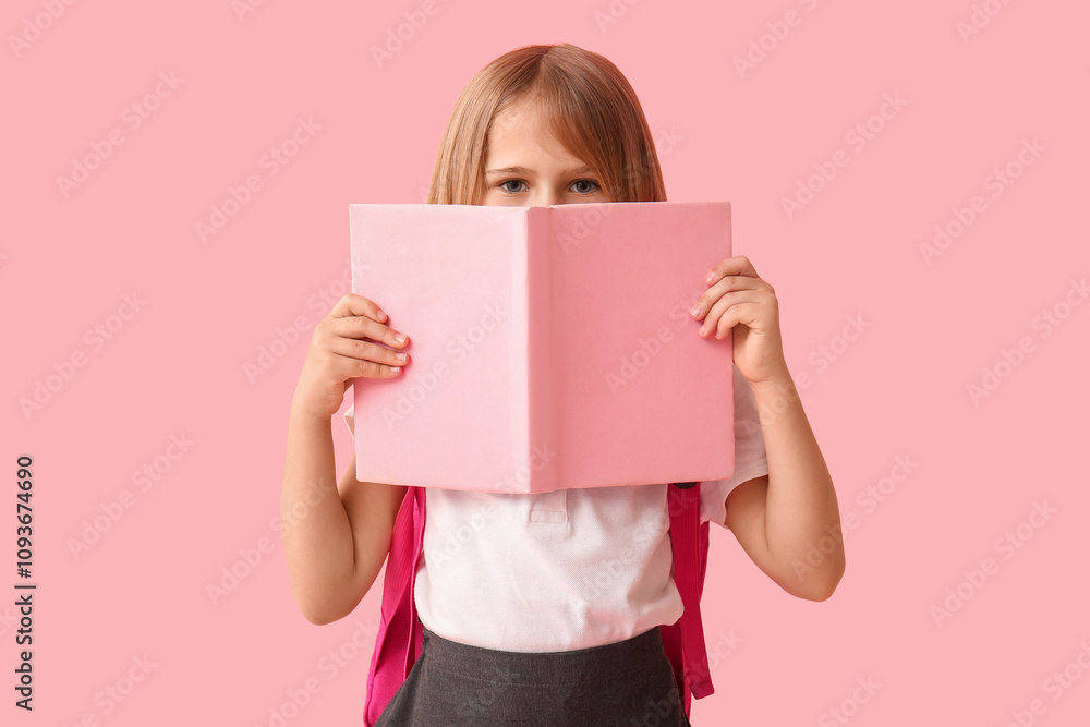 Cute little schoolgirl with backpack and book on pink background Cute little schoolgirl with backpack and book on pink background