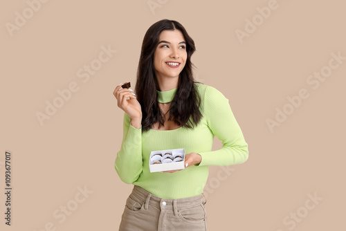 Happy young woman with box ...