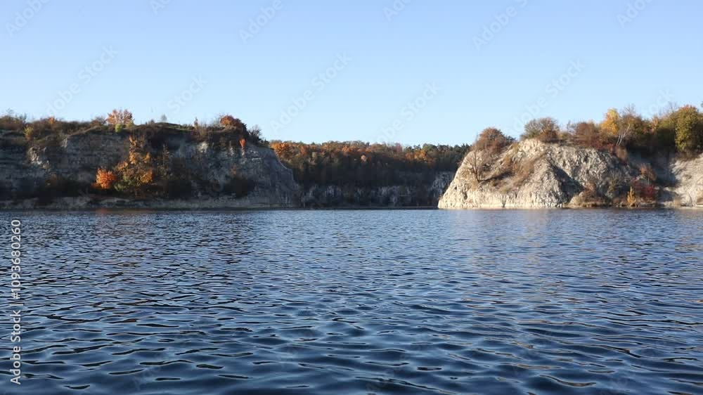 Lake Zakrzówek with Rocks and Autumn Trees. Beautiful Scenery of Nature in Krakow. Blue Water during Fall Season in Poland. Lake Zakrzówek with Rocks and Autumn Trees. Beautiful Scenery of Nature in Krakow. Blue Water during Fall Season in Poland.