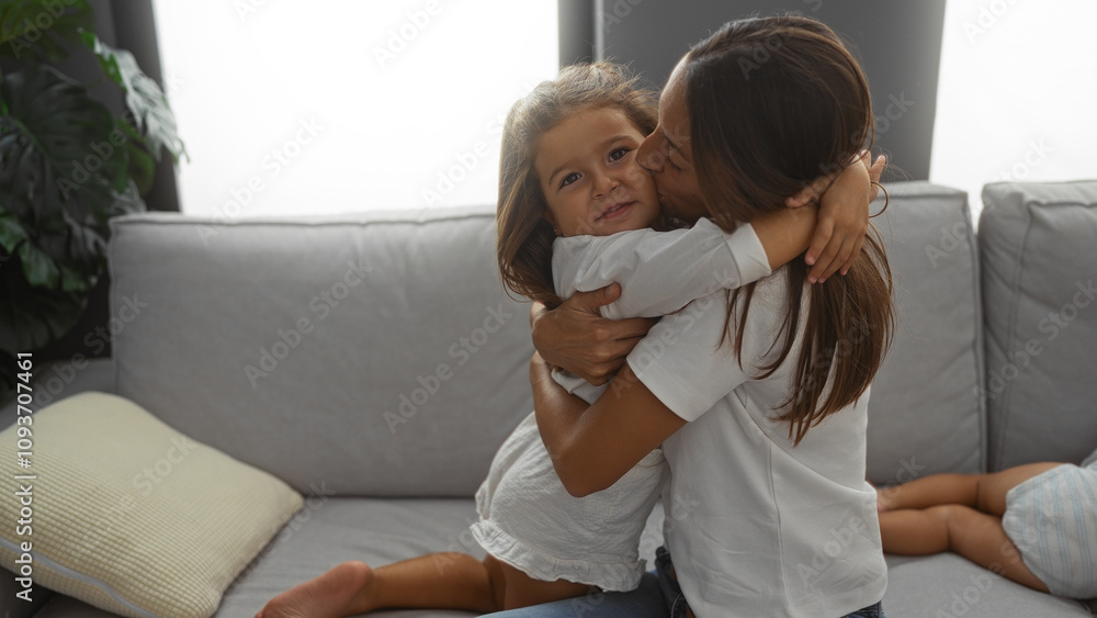 Woman hugging daughter lovingly in a cozy living room, expressing family warmth and connection, with a soft embrace illustrating the bond and happiness of home life. Woman hugging daughter lovingly in a cozy living room, expressing family warmth and connection, with a soft embrace illustrating the bond and happiness of home life.