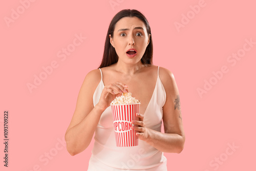 Shocked young woman eating ...