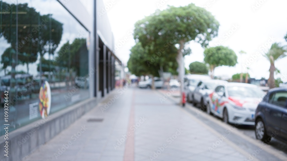 Blurred view of a street with cars and trees in lanzarote, spain, showcasing an urban outdoor scene with a defocused background and bokeh effects Blurred view of a street with cars and trees in lanzarote, spain, showcasing an urban outdoor scene with a defocused background and bokeh effects