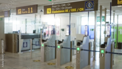 Defocused view of an airport terminal with blurred passport control gates and signs in eu zone creating a travel ambiance