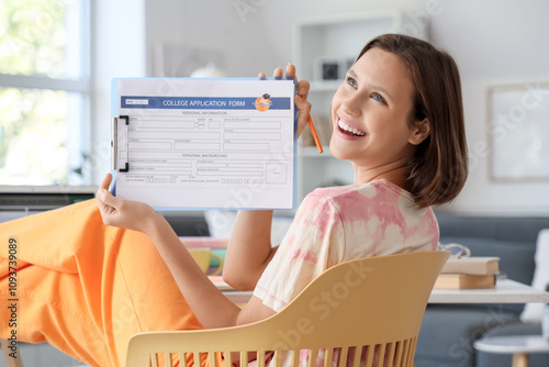 Happy young woman holding c...