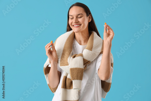 Young woman with ear plugs ...