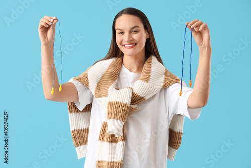 Young woman with ear plugs ...