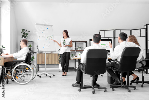 Wallpaper Mural Young Asian woman with plant giving presentation to her colleagues during business meeting in office. Green energy concept Torontodigital.ca