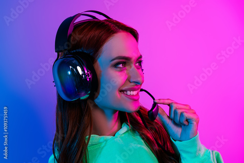 Photo of charming positive woman wear green sweatshirt headphones talking mic isolated neon blue color background photo