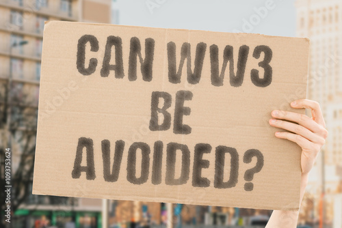 Wallpaper Mural The phrase 'Can WW3 be avoided?' on a banner in a person's hand. Human holds a cardboard with an inscription. Peace. Diplomacy. Unity. Conflict. Resolution. Strategy. Hope Torontodigital.ca