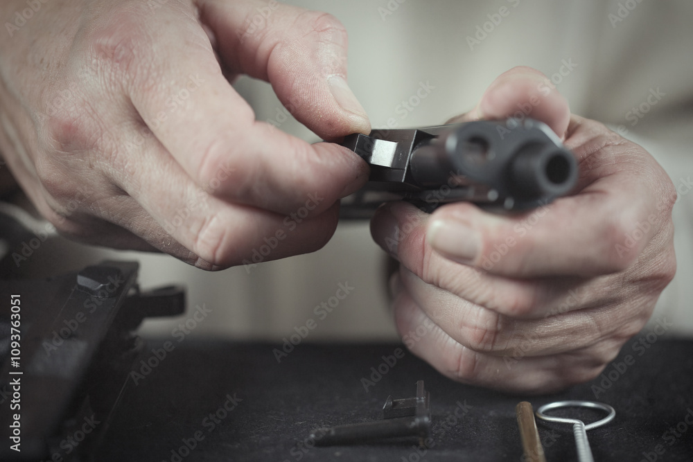 Fototapeta premium Man take care of semi automatic pistol handgun at home
