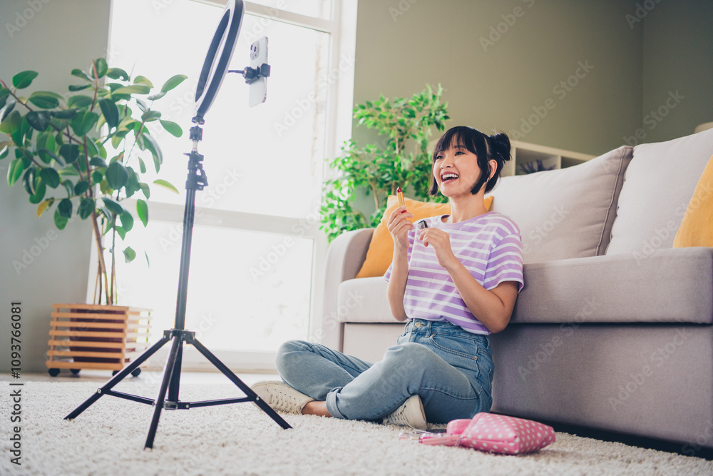 Photo of shiny cute girl dressed purple striped t-shirt promoting pomade recording vlog modern gadget indoors house apartment room Photo of shiny cute girl dressed purple striped t-shirt promoting pomade recording vlog modern gadget indoors house apartment room
