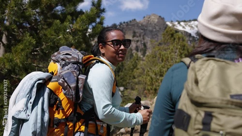 Wallpaper Mural Two young women doing hiking together, conversing in the middle of the forest during wintertime. Active people doing outdoors activities in the nature. Video with copy space. Torontodigital.ca