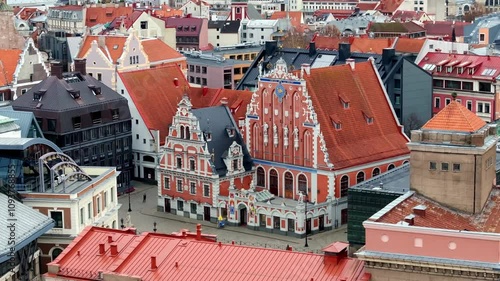 The image shows an aerial perspective of Riga, Latvia, focusing on the House of the Blackheads. The area is filled with colorful European architecture.