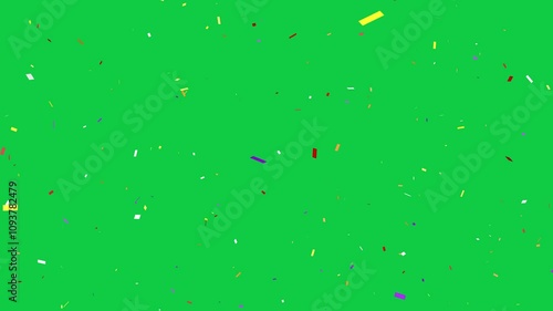 Confetti over green screen. Celebration of ticker tape being dropped. Editing or compositing chroma key overlay.