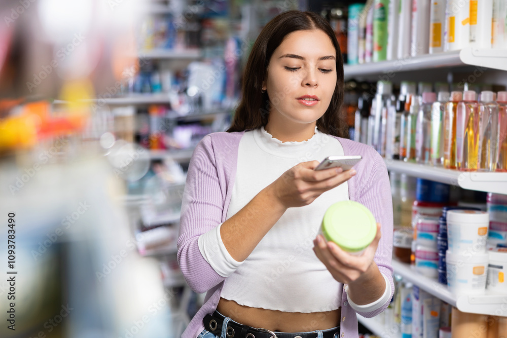Female customer takes a photo using a mobile phone in a cosmetics store Female customer takes a photo using a mobile phone in a cosmetics store