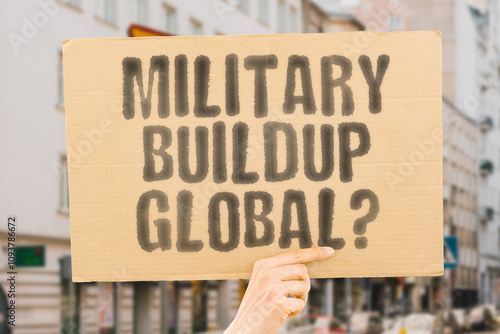 Wallpaper Mural The phrase 'Military buildup global?' on a banner in a person's hand. Human holds a cardboard with an inscription. Conflict. Tension. Nations. Power. Security. Diplomacy. Defense Torontodigital.ca