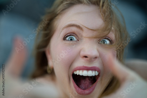 Closeup portrait of Young Excited Woman show thumb up. Excited people. Female hand showing thumb up near funny excited face. A hand giving a thumbs up. Happy Woman with thumb up. Excited woman.