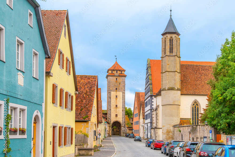 Fototapeta premium View of the medieval Spital Bastion from one of the many picturesque streets of half-timbered buildings in the Bavarian village of Rothenburg ob Der Tauber, Germany. 