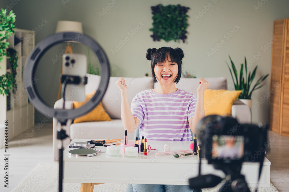 Photo of adorable lucky lady wear violet striped t-shirt recording beauty video modern device indoors room home house Photo of adorable lucky lady wear violet striped t-shirt recording beauty video modern device indoors room home house