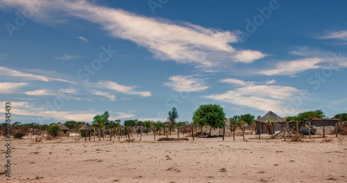african village in the desert with rondavel and mud hut with thatched roof in the sand , damaraland vista landscape