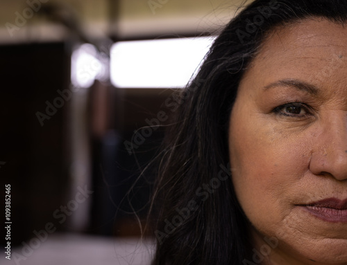 Close-up of mature senior woman with thoughtful expression at home, copy space photo