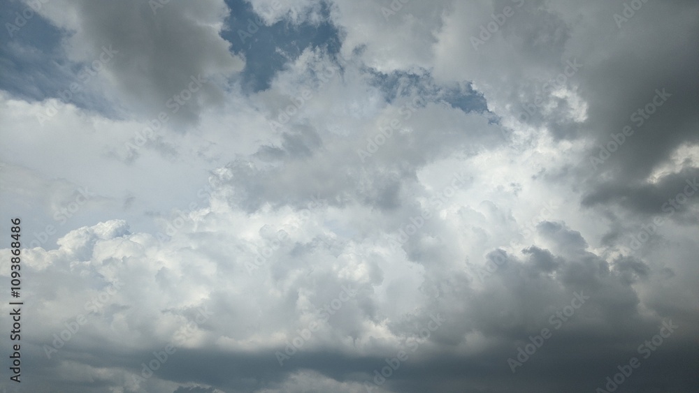 A dramatic sky filled with swirling, gray clouds. The clouds create a sense of depth and movement, with patches of lighter gray suggesting breaks in the overcast. A dramatic sky filled with swirling, gray clouds. The clouds create a sense of depth and movement, with patches of lighter gray suggesting breaks in the overcast.